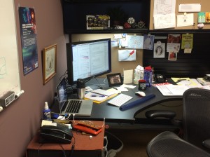 The main thesis editing desk: laptop, external monitor keyboard mouse; coffee, water; notes; and lots of encouragement. 